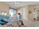Bedroom with window, ceiling fan and access to another room at 37181 N 103Rd St, Scottsdale, AZ 85262