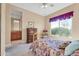 Bright bedroom with carpeted floors and ensuite bathroom access at 37181 N 103Rd St, Scottsdale, AZ 85262