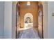 Pathway through arched entryway to courtyard with fountain at 37181 N 103Rd St, Scottsdale, AZ 85262