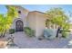 Front entrance with wooden doors and desert landscaping at 37181 N 103Rd St, Scottsdale, AZ 85262