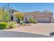 Single-story home with desert landscaping and a three-car garage at 37181 N 103Rd St, Scottsdale, AZ 85262