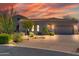 Single-story home with tile roof and desert landscaping at dusk at 37181 N 103Rd St, Scottsdale, AZ 85262
