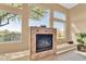 Elegant fireplace with built-in seating and large windows offering scenic views at 37181 N 103Rd St, Scottsdale, AZ 85262