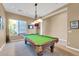Game room with pool table, decorative lighting, and wall-mounted TV at 37181 N 103Rd St, Scottsdale, AZ 85262