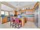 Spacious kitchen with an island, wood cabinets and granite countertops at 37181 N 103Rd St, Scottsdale, AZ 85262