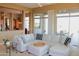 Open living room showcasing a sectional sofa and views into the kitchen at 37181 N 103Rd St, Scottsdale, AZ 85262