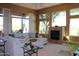 Relaxing living room with sectional sofa, fireplace, and access to backyard at 37181 N 103Rd St, Scottsdale, AZ 85262