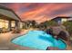 Inviting pool with waterfall and ample lounge space at 37181 N 103Rd St, Scottsdale, AZ 85262