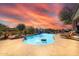 Luxury pool with rock waterfall and lounge chairs at 37181 N 103Rd St, Scottsdale, AZ 85262