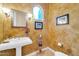 Stylish powder room with pedestal sink and decorative wall finish at 37181 N 103Rd St, Scottsdale, AZ 85262