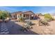 Desert landscaping with gravel, cacti, and a covered patio at 40950 W Bedford Dr, Maricopa, AZ 85138