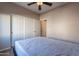 Spacious bedroom with double door closet and ceiling fan at 40950 W Bedford Dr, Maricopa, AZ 85138