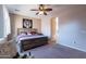 Spacious bedroom with large window and rustic furniture at 40950 W Bedford Dr, Maricopa, AZ 85138