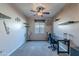 Home office with built-in shelves and a large window at 40950 W Bedford Dr, Maricopa, AZ 85138