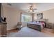 Large bedroom with a rustic wooden bed and ceiling fan at 40950 W Bedford Dr, Maricopa, AZ 85138