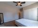 Simple bedroom with ceiling fan and double door closet at 40950 W Bedford Dr, Maricopa, AZ 85138