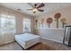 Charming bedroom with floral wall art and ceiling fan at 40950 W Bedford Dr, Maricopa, AZ 85138