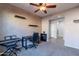 Home office with a desk, chair, and musical instrument at 40950 W Bedford Dr, Maricopa, AZ 85138