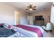Spacious bedroom with large bed, dresser, and ceiling fan at 40950 W Bedford Dr, Maricopa, AZ 85138