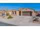 One-story house with a two-car garage and desert landscaping at 40950 W Bedford Dr, Maricopa, AZ 85138