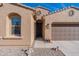House entrance with a brown door and stone pathway at 40950 W Bedford Dr, Maricopa, AZ 85138