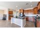 Open concept kitchen with island and stainless steel appliances at 40950 W Bedford Dr, Maricopa, AZ 85138