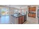 Kitchen with island, double sink, and access to backyard at 40950 W Bedford Dr, Maricopa, AZ 85138