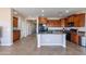 Kitchen features island, ample cabinetry, and stainless steel appliances at 40950 W Bedford Dr, Maricopa, AZ 85138