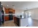 Open concept kitchen with island and access to patio at 40950 W Bedford Dr, Maricopa, AZ 85138