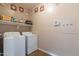 Laundry room with washer, dryer, and shelving at 40950 W Bedford Dr, Maricopa, AZ 85138