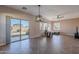 Bright living room with tile floors, sliding glass door, and comfortable seating at 40950 W Bedford Dr, Maricopa, AZ 85138