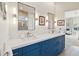 Elegant bathroom with double vanity and blue cabinets at 41704 N Emerald Lake Dr, Anthem, AZ 85086