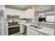 Kitchen with white cabinets, stainless steel appliances, and a double sink at 4608 W Maryland Ave # 127, Glendale, AZ 85301