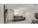 Living room with tile floors, a brown leather couch and a staircase at 4608 W Maryland Ave # 127, Glendale, AZ 85301