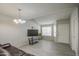 Living room with tile floors, a brown leather couch and a flat screen TV at 4608 W Maryland Ave # 127, Glendale, AZ 85301