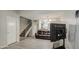 Living room with tile floors, a brown leather couch and a staircase at 4608 W Maryland Ave # 127, Glendale, AZ 85301
