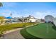 Large backyard oasis with putting green and shed at 4942 E Wethersfield Rd, Scottsdale, AZ 85254