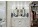 Elegant bathroom with double vanity and walk-in closet at 4942 E Wethersfield Rd, Scottsdale, AZ 85254