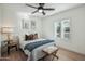 Spacious bedroom with light wood floors and window shutters at 4942 E Wethersfield Rd, Scottsdale, AZ 85254