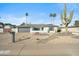 Ranch-style home with gray garage door and well-maintained desert landscaping at 4942 E Wethersfield Rd, Scottsdale, AZ 85254