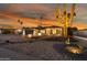 Stunning curb appeal with desert landscaping, lighting, and a large saguaro cactus at 4942 E Wethersfield Rd, Scottsdale, AZ 85254