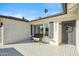 Front porch with tile flooring and a wicker bench, offering a welcoming entrance at 4942 E Wethersfield Rd, Scottsdale, AZ 85254