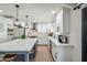 Renovated kitchen featuring white shaker cabinets, quartz countertops, and a large island at 4942 E Wethersfield Rd, Scottsdale, AZ 85254