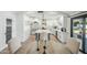 Modern kitchen with white cabinets, a large island, and a farmhouse sink at 4942 E Wethersfield Rd, Scottsdale, AZ 85254
