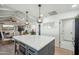 Modern kitchen with white cabinets, quartz countertops, and an island with seating at 4942 E Wethersfield Rd, Scottsdale, AZ 85254