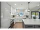 Modern kitchen with white cabinets, a large island, and a view of the backyard at 4942 E Wethersfield Rd, Scottsdale, AZ 85254