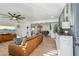 Open living space with hardwood floors, leather couch, and a view into the dining area at 4942 E Wethersfield Rd, Scottsdale, AZ 85254