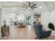 Open concept living area with vaulted ceilings, wood floors, and a cozy seating area at 4942 E Wethersfield Rd, Scottsdale, AZ 85254