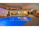 Backyard pool with patio cover at night at 4942 E Wethersfield Rd, Scottsdale, AZ 85254