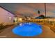 Stunning illuminated pool at night at 4942 E Wethersfield Rd, Scottsdale, AZ 85254